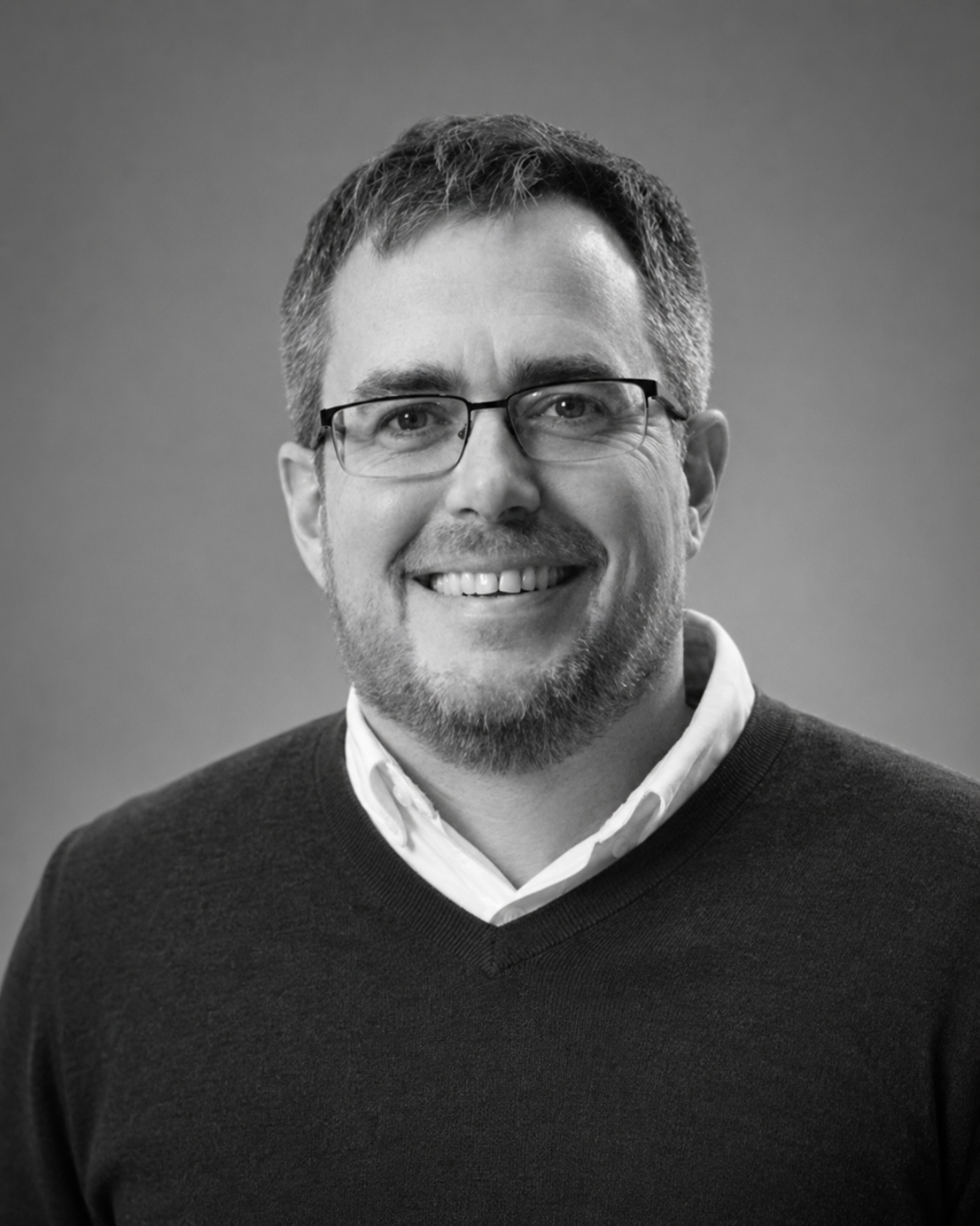 Black-and-white headshot of Bruce Davis, Chair of the UK Crowdfunding Association and Abundance Investment co-founder, newly appointed GECA Steering Committee Strategic Advisor — UK.